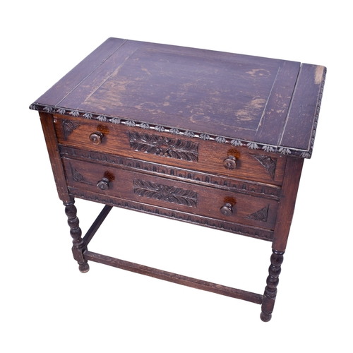 166 - A carved oak writing table. Having two graduated drawers with turned handles, raised on barley twist... 