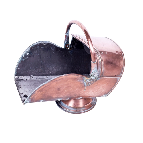 178 - A copper coal scuttle. Having a swing handle and mounted on a circular base, H44cm.