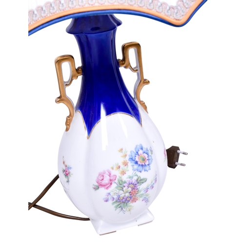 186 - A pair of Limoges ceramic lamp bases with shades. Both of baluster form, glazed in white with blue a... 