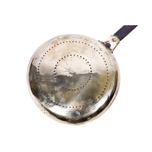 192 - A vintage bed warmer. Having a metal handle and brass cover with impressed decoration, L97.5cm.