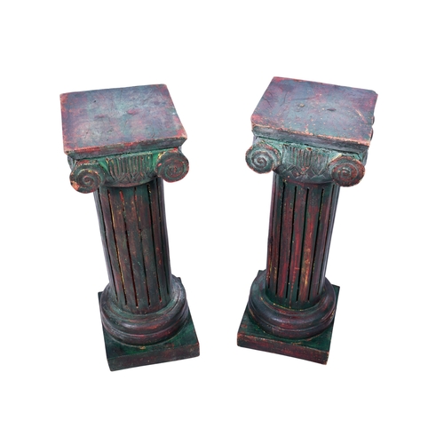 200 - A pair of carved wooden stands. Modelled as Corinthian columns, mounted on square bases, painted gre... 