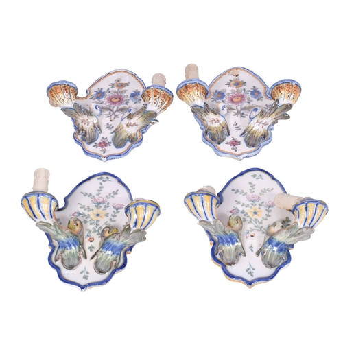 217 - Two pairs of faience Portugese ceramic wall sconces. Both glazed in white with two branches fitted w... 