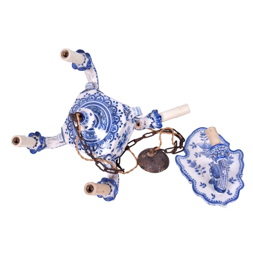 218 - A Portugese ceramic wall sconce and a four branch chandelier. Both glazed in white with blue decorat... 