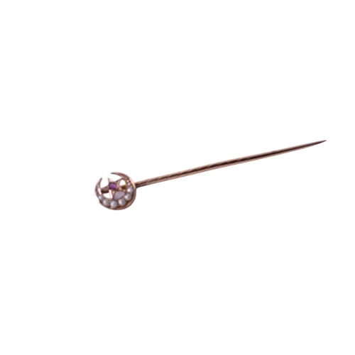 28 - A yellow metal tie pin. Topped with a stone and pearl set star and crescent moon, marked 15ct to ver... 