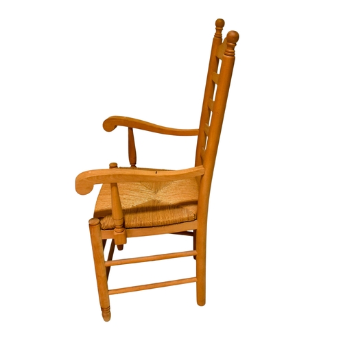 377 - A pair of vintage ladder back kitchen chairs. The wooden frames having turned finials and scroll arm... 