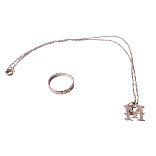 43 - A 9ct gold ring and a yellow metal 'M' pendant and chain. The ring set with small colourless stones,... 