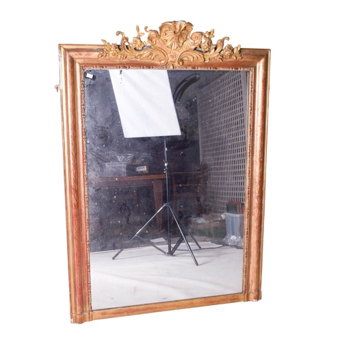 625 - A 19th century large gilt framed rectangular wall mirror. The frame having floral engraved decoratio... 