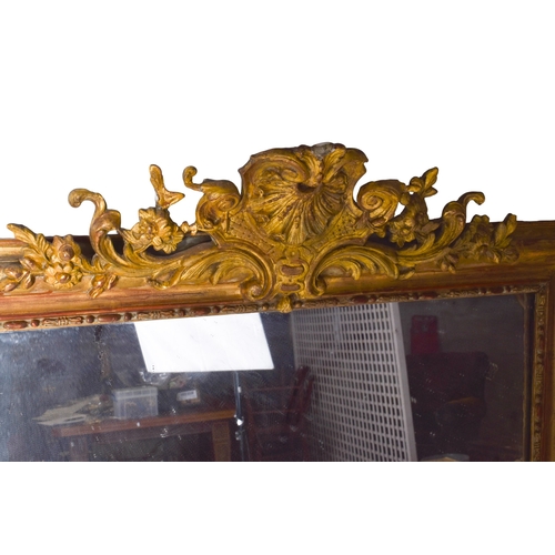 625 - A 19th century large gilt framed rectangular wall mirror. The frame having floral engraved decoratio... 
