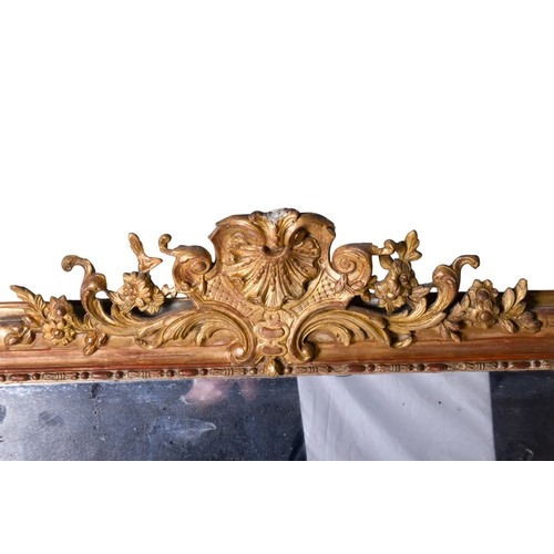 625 - A 19th century large gilt framed rectangular wall mirror. The frame having floral engraved decoratio... 