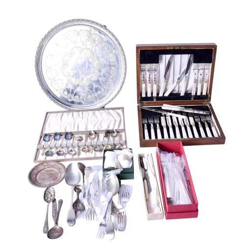 99 - An assortment of silverplated table items. Including a circular tray with engraved decoration, a set... 