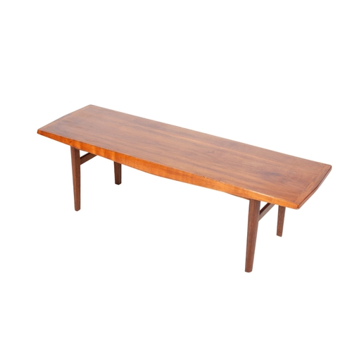 486 - A mid-century teak coffee table in the style of Gordon Russell. The rectangular top mounted on turne... 