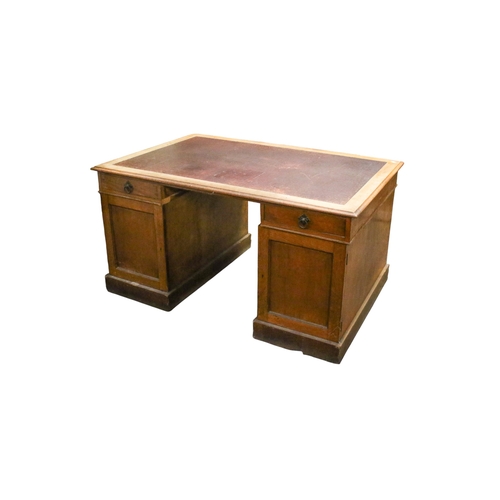 551 - An early 20th century oak twin pedestal partner's desk. Having an inset top drawer to one side and c... 