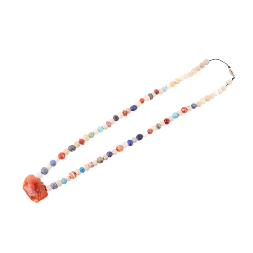 62 - A string of possibly Roman beads with an amygdaloid carnelian pendant, possibly Minoan. The small be... 