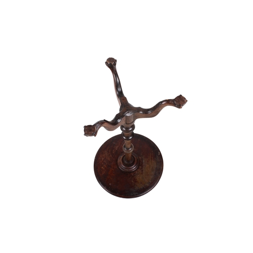 160 - An early 20th century mahogany wine table. The circular top mounted on a turned and tapered stand te... 