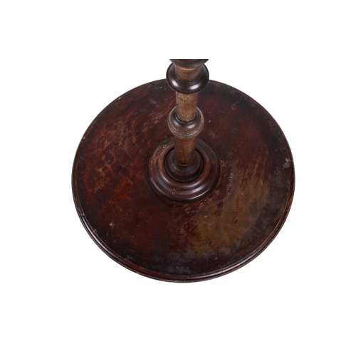 160 - An early 20th century mahogany wine table. The circular top mounted on a turned and tapered stand te... 