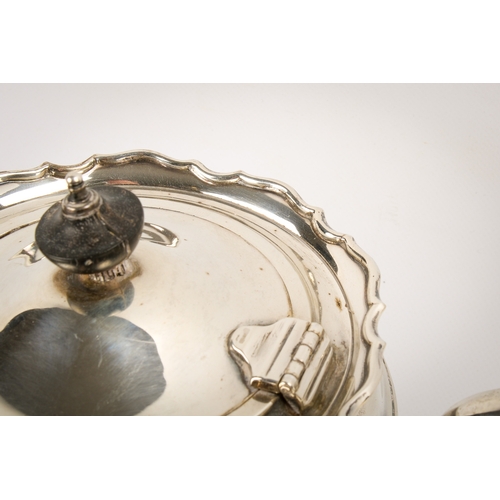 10 - An early 20th century silver teapot, sugar bowl and cream jug set. With fluted rim over a ribbed bod... 