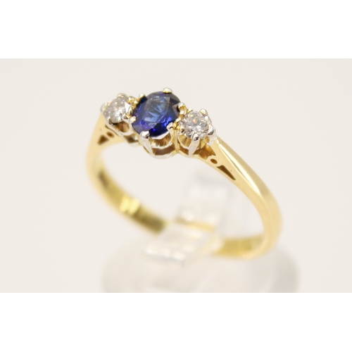 102 - A hallmarked 18ct gold three stone ring. Set with one oval faceted sapphire of 0.48 carats estimated... 