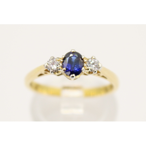 102 - A hallmarked 18ct gold three stone ring. Set with one oval faceted sapphire of 0.48 carats estimated... 