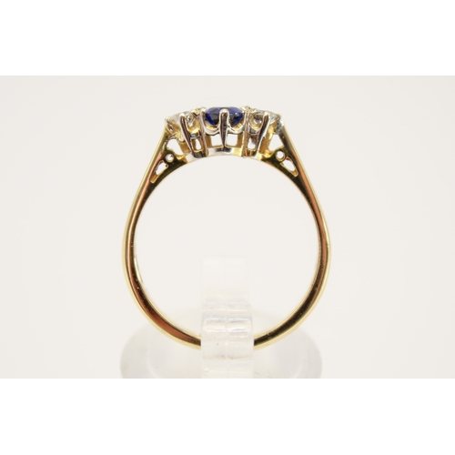 102 - A hallmarked 18ct gold three stone ring. Set with one oval faceted sapphire of 0.48 carats estimated... 