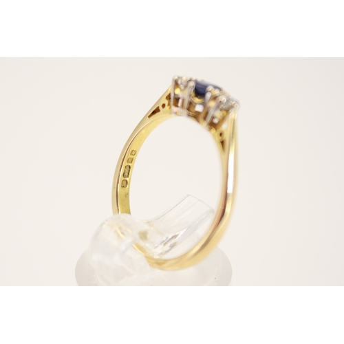 102 - A hallmarked 18ct gold three stone ring. Set with one oval faceted sapphire of 0.48 carats estimated... 
