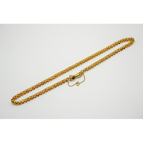 136 - A yellow metal necklace with hand form clasp. Of triple cable link form, the clasp in the form of a ... 