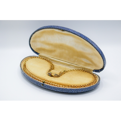 136 - A yellow metal necklace with hand form clasp. Of triple cable link form, the clasp in the form of a ... 