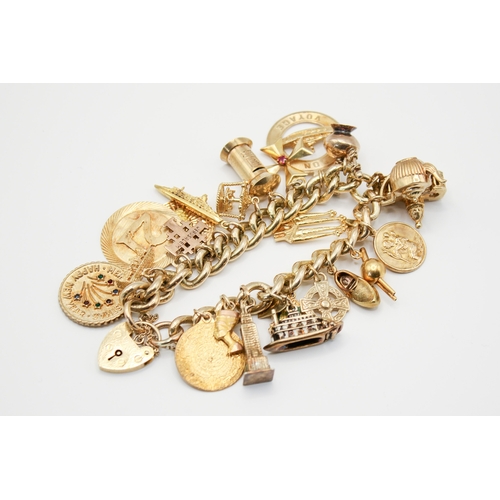 147 - A 9ct gold charm bracelet with 23 assorted gold and yellow metal charms. Charms include a post box, ... 