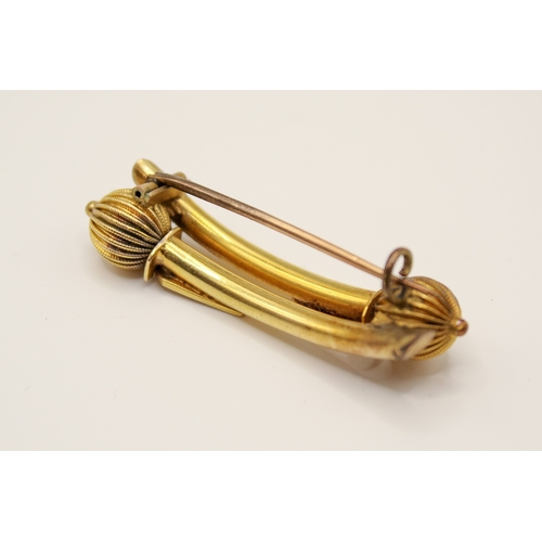 154 - A 19th century yellow metal Etruscan style bar brooch. Of double baton form with textured details, u... 