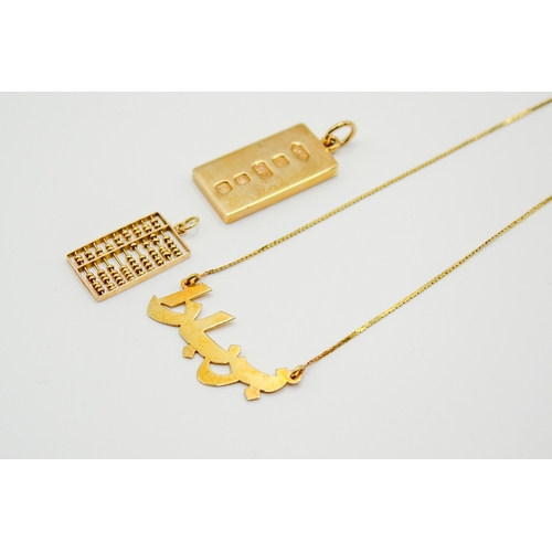 168 - Three gold and yellow metal pendants and necklace. Including a hallmarked 9ct gold ingot, weight 15.... 