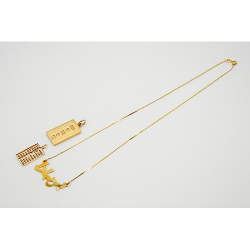 168 - Three gold and yellow metal pendants and necklace. Including a hallmarked 9ct gold ingot, weight 15.... 