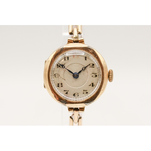 233 - A 9ct gold cased lady's watch. Manual movement, the silvered dial with Arabic numerals, in a hallmar... 
