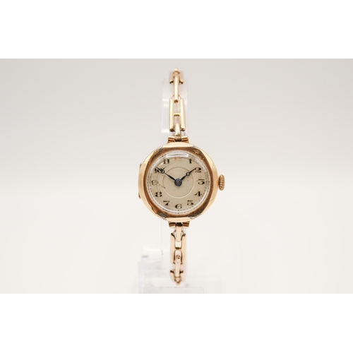 233 - A 9ct gold cased lady's watch. Manual movement, the silvered dial with Arabic numerals, in a hallmar... 