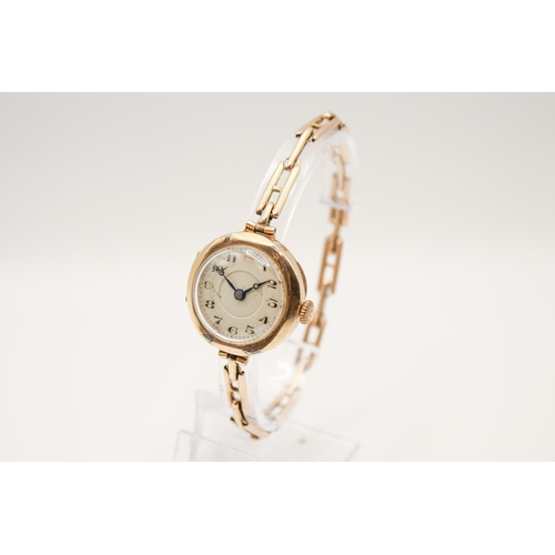 233 - A 9ct gold cased lady's watch. Manual movement, the silvered dial with Arabic numerals, in a hallmar... 
