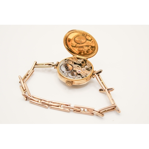 233 - A 9ct gold cased lady's watch. Manual movement, the silvered dial with Arabic numerals, in a hallmar... 