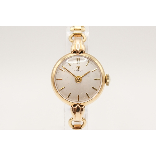238 - A 9ct gold vintage lady's Tissot dress watch. The round face with gilt marker, hallmarked inside bac... 