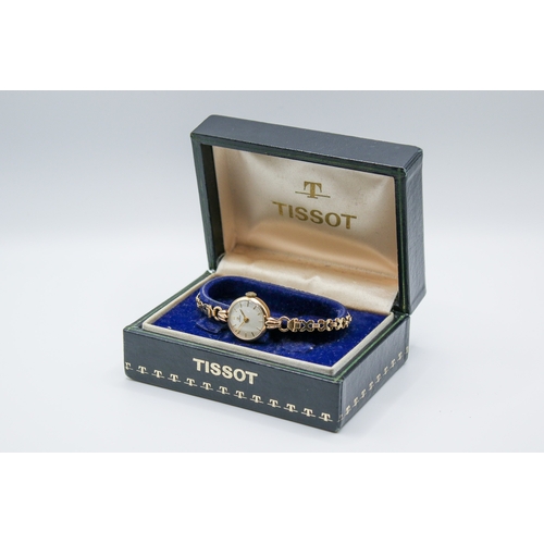 238 - A 9ct gold vintage lady's Tissot dress watch. The round face with gilt marker, hallmarked inside bac... 