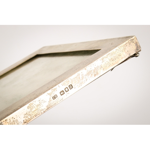 30 - A silver desk calendar and a silver photograph frame. The calendar of Art Nouveau style with loose m... 