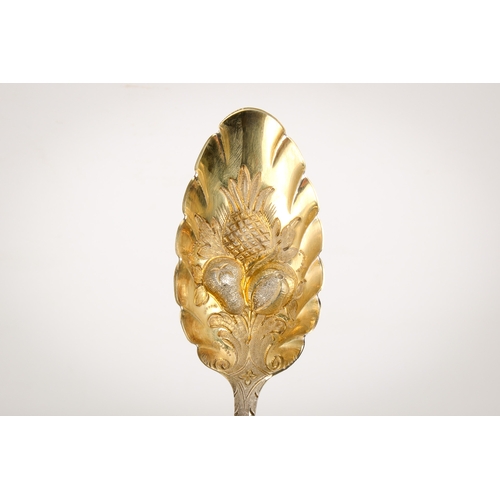 44 - A pair of George III silver berry spoons. The gilt bowls with repoussé decoration of a pineapple and... 