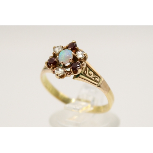 86 - An 18ct gold (tested) dress ring. Set centrally with one oval cabochon cut opal of 0.17 carats with ... 