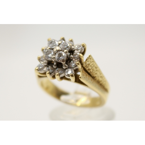 97 - An 18ct gold and diamond cluster ring. Set with sixteen small round cut diamonds in a raised, square... 