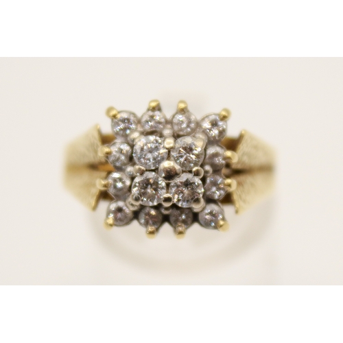 97 - An 18ct gold and diamond cluster ring. Set with sixteen small round cut diamonds in a raised, square... 