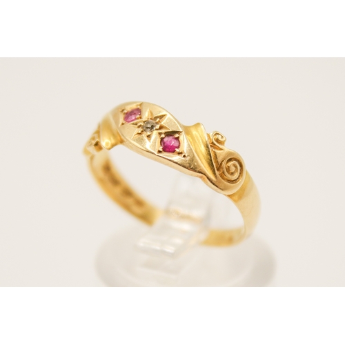 110A - An 18ct gold ring. With two small rubies and diamond in a scroll setting, hallmarked, size O1/2, gro... 