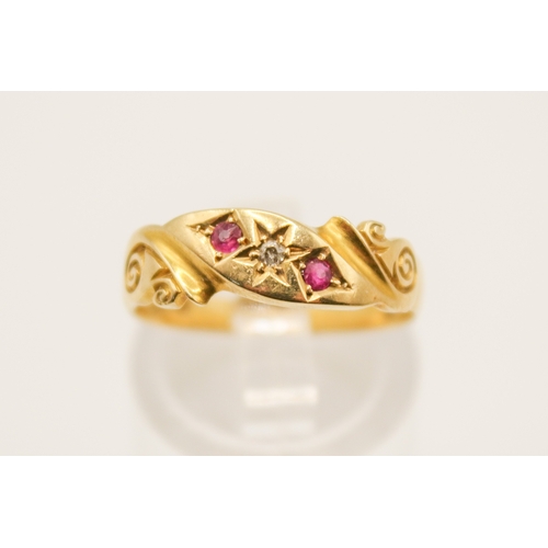 110A - An 18ct gold ring. With two small rubies and diamond in a scroll setting, hallmarked, size O1/2, gro... 