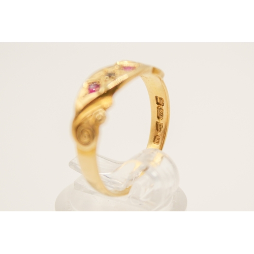 110A - An 18ct gold ring. With two small rubies and diamond in a scroll setting, hallmarked, size O1/2, gro... 