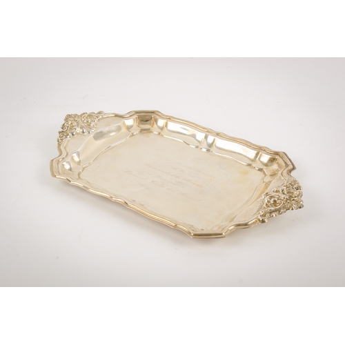 25A - A Spanish silver tray. Of shaped rectangular form, the extending handles decorated in relief with sc... 