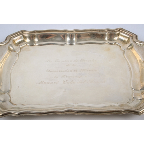 25A - A Spanish silver tray. Of shaped rectangular form, the extending handles decorated in relief with sc... 