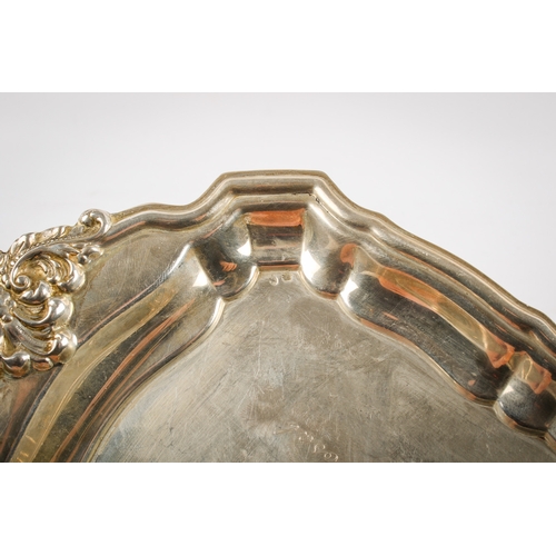 25A - A Spanish silver tray. Of shaped rectangular form, the extending handles decorated in relief with sc... 