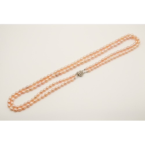 170a - A double strand of pale pink freshwater pearls. Of variegated tone and shape, each bead circa 8mm lo... 