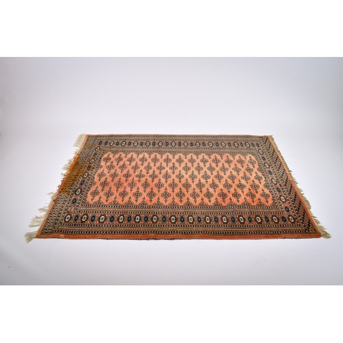 171 - A Persian style wool rug on a cinnamon ground. Having multiple geometric borders with traditional st... 