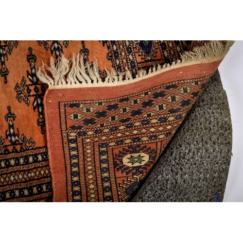171 - A Persian style wool rug on a cinnamon ground. Having multiple geometric borders with traditional st... 